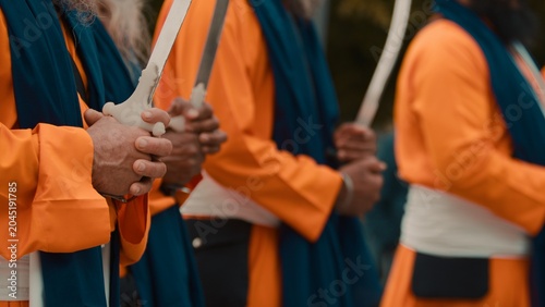 Indian soldiers with swords Kirpan praying for the Vaisakhi religion parade