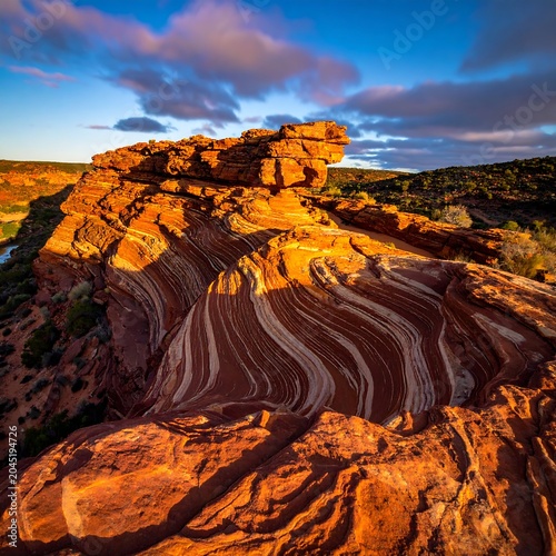 Vivid Layered Sandstone Formation Glowing at Sunset in Desert Landscape