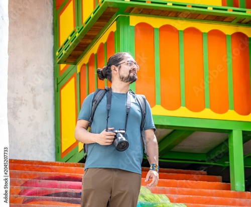 Male photographer on colorful stairs in Colombia coffee region