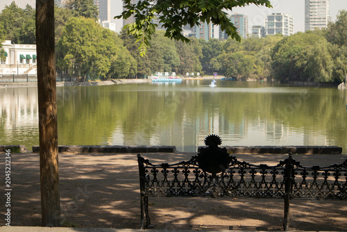 Chapultepec Lake in Mexico City. Peaceful urban lake surrounded by lush trees and modern city buildings
