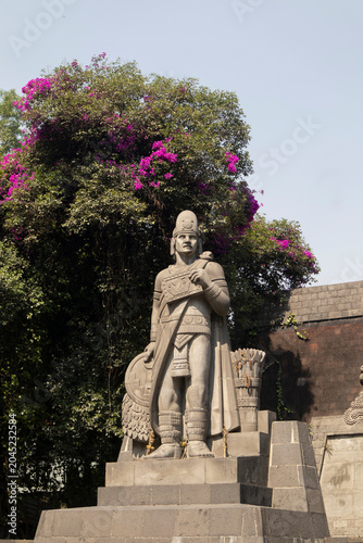 Nezahualcóyotl Fountain in Chapultepec. Historic monument that features a statue of an Aztec warrior and intricate stone reliefs in Mexico City