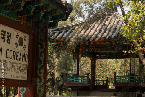 Traditional Korean pavilion structure with ornate wooden architecture and decorative details on the roof located in Chapultepec, Mexico City