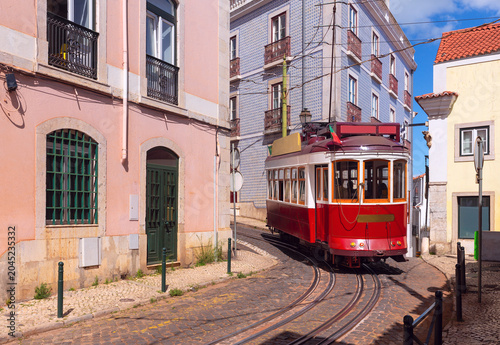 Historic Red Tram on Narrow Street in Alfama District Lisbon Portugal