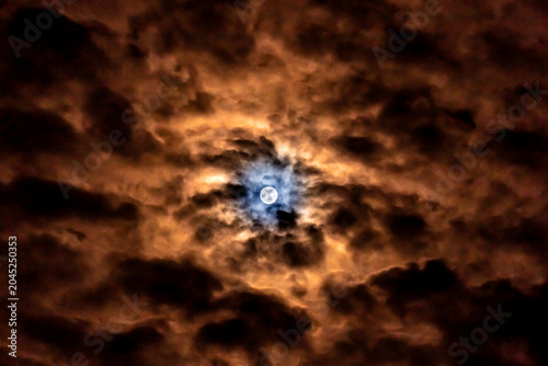  Super full moon in the night sky with clouds,