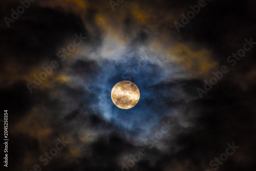  Super full moon in the night sky with clouds,