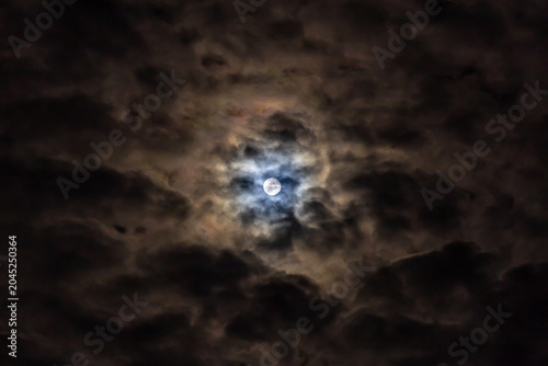  Super full moon in the night sky with clouds,