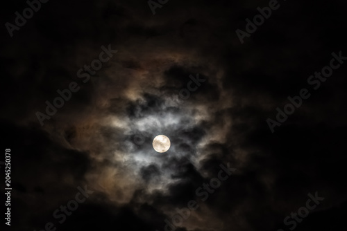  Super full moon in the night sky with clouds,