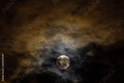  Super full moon in the night sky with clouds,