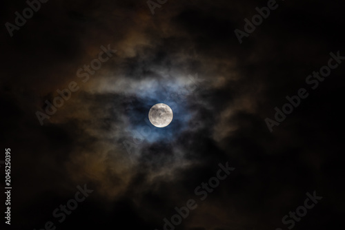  Super full moon in the night sky with clouds,