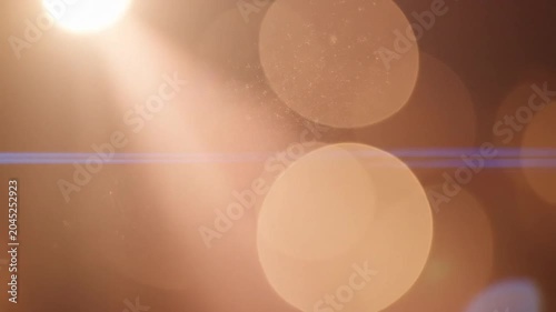 Warm golden bokeh lights with lens flare abstract background