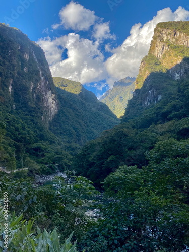 Photography Dramatic green canyon with steep cliffs and clouds in the Andes of Peru