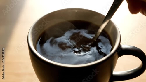 Black Coffee Being Stirred in Ceramic Cup. 4K Video