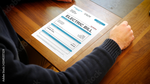 Tableau sur toile A Stressed Homeowner looks at a Electrical Bill