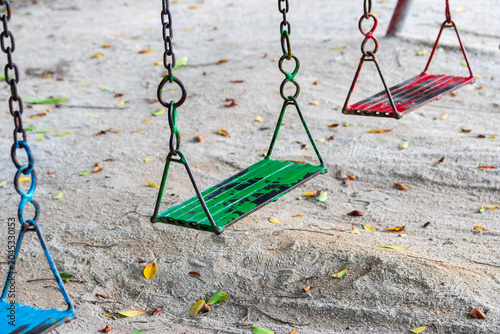 Educational Parenting. Empty Metal Chain Swing in Playground