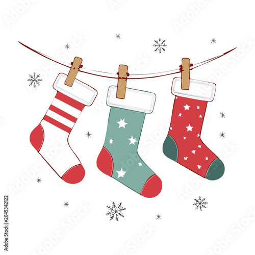Three Christmas stockings hanging on a clothesline with snowflakes