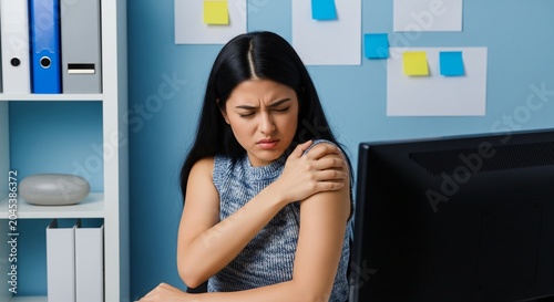 Woman with Shoulder Pain at Desk