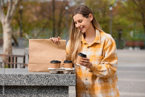 Young woman with paper bag ...