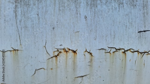 Photos A metal surface covered with rust, peeling paint, cracks and streaks, and oxide residues