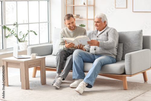 Senior man and his son with...