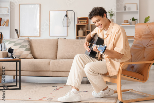 Young happy man playing new...