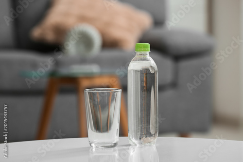 Bottle of water and glass o...