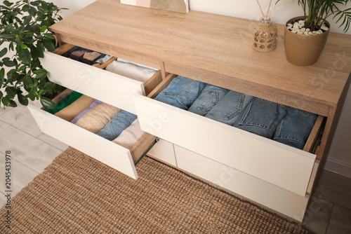 Folded clothes in dresser w...