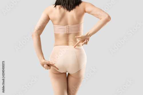 Young woman in beige menstr...