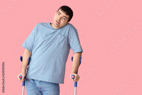 Young man with crutches on ...