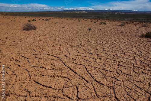 Fotografie Dry, cracked soil in the desert due to severe drought in the region