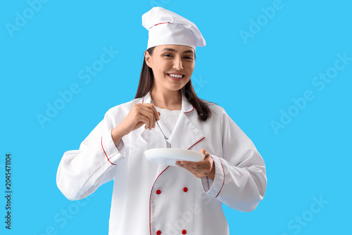Female chef with fork and p...
