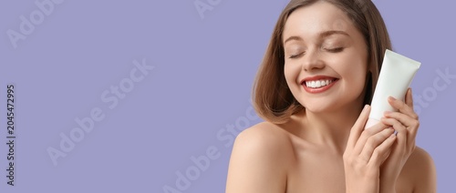 Happy young woman holding t...