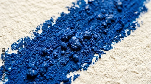 Vibrant blue pigment streak on textured paper
