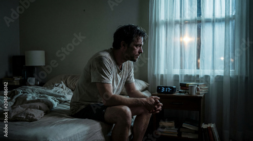 Man Awake at Night in Dark Bedroom