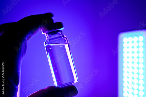Hand holding innovative glp 1 peptide medication vial developing anti obesity drug