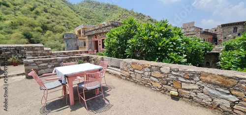 Outdoor Rooftop Sitting Area with Table and Chairs at the Historic Dadhikar Fort in Alwar Rajasthan India