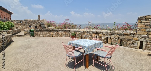 Outdoor Rooftop Sitting Area with Table and Chairs at the Historic Dadhikar Fort in Alwar Rajasthan India