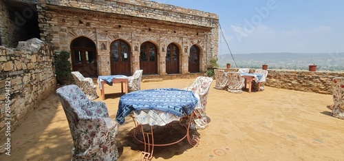 Outdoor Rooftop Sitting Area with Table and Chairs at the Historic Dadhikar Fort in Alwar Rajasthan India