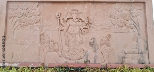 Intricate Traditional Indian Carvings and Religious Relief Designs on Sandstone wall at Heritage Corridor in Ujjain, Madhya Pradesh, India 