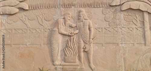 Intricate Traditional Indian Carvings and Religious Relief Designs on Sandstone wall at Heritage Corridor in Ujjain, Madhya Pradesh, India 