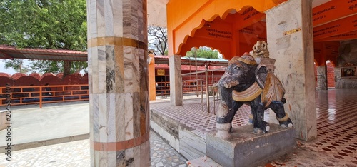 Stone Elephant Statue Guarding the Entrance of a Traditional Indian Temple Complex