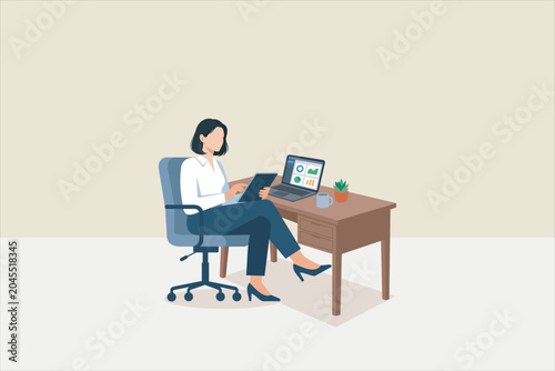 Fotografie Professional businesswoman working at office desk with laptop and tablet, analyzing data charts and reports