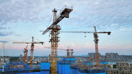 Tower Cranes Over Urban Construction Site at Dusk