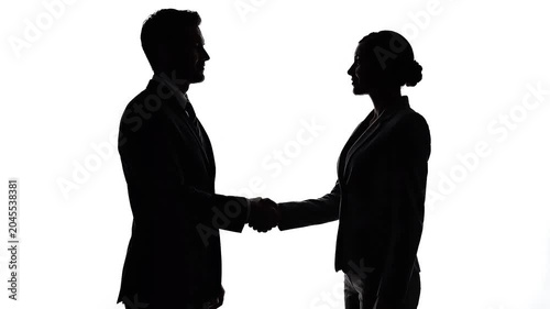 Silhouette of businessman and businesswoman shaking hands on white background