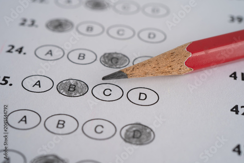 Answer sheets with pencil drawing fill to select choice, education concept.