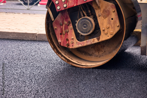 Canvas Print Workers are busy paving an urban road with asphalt