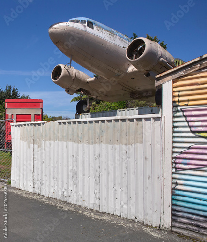 Fotografie Antique and vintage aeroplane behind metal fence at Shannon Taranaki