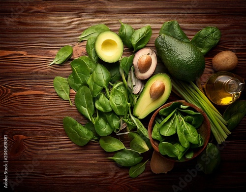 Fresh Organic Avocado and Spinach Ingredients Laid Out on a Rustic Wooden Table Top View