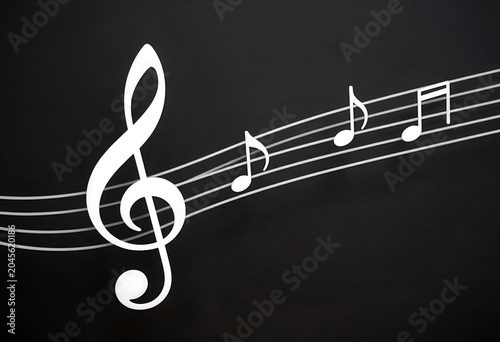White treble clef and musical notes on a wavy staff lines