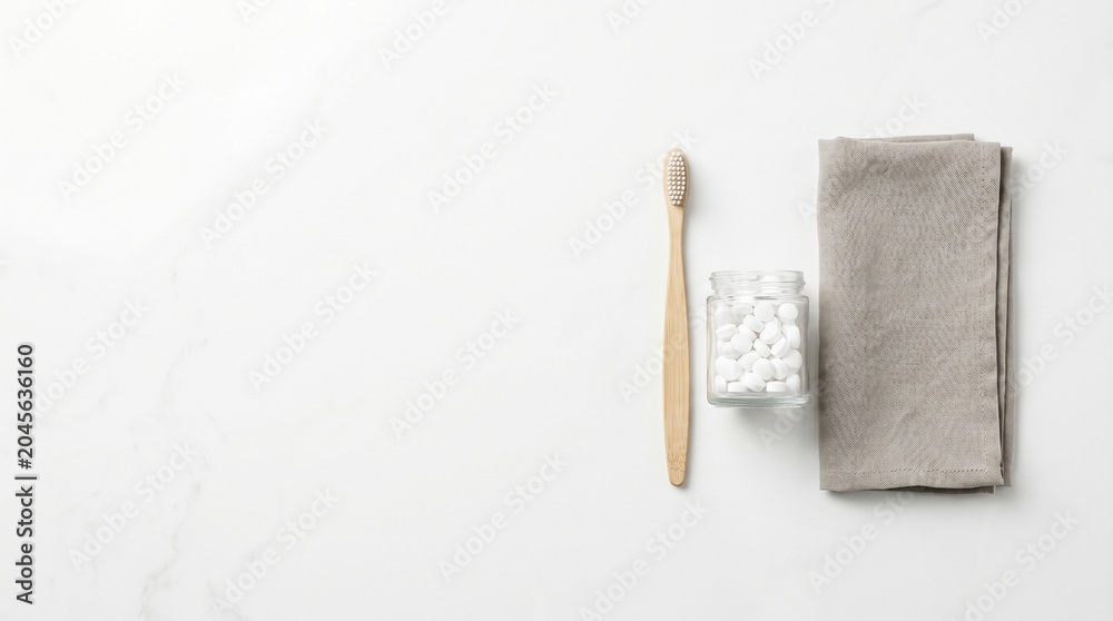 Obraz premium Bamboo toothbrush with eco friendly toothpaste tablets on white marble.