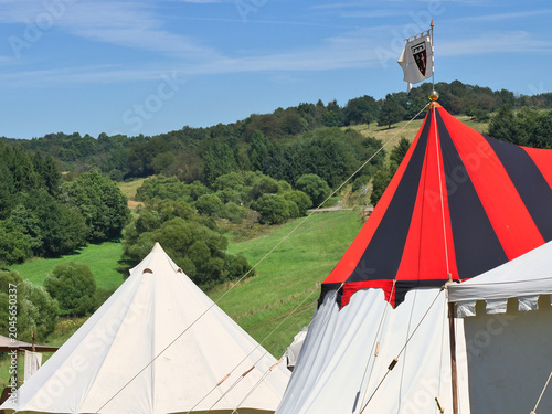 Tableau sur toile Medieval encampment with knight tents in a summer landscape
